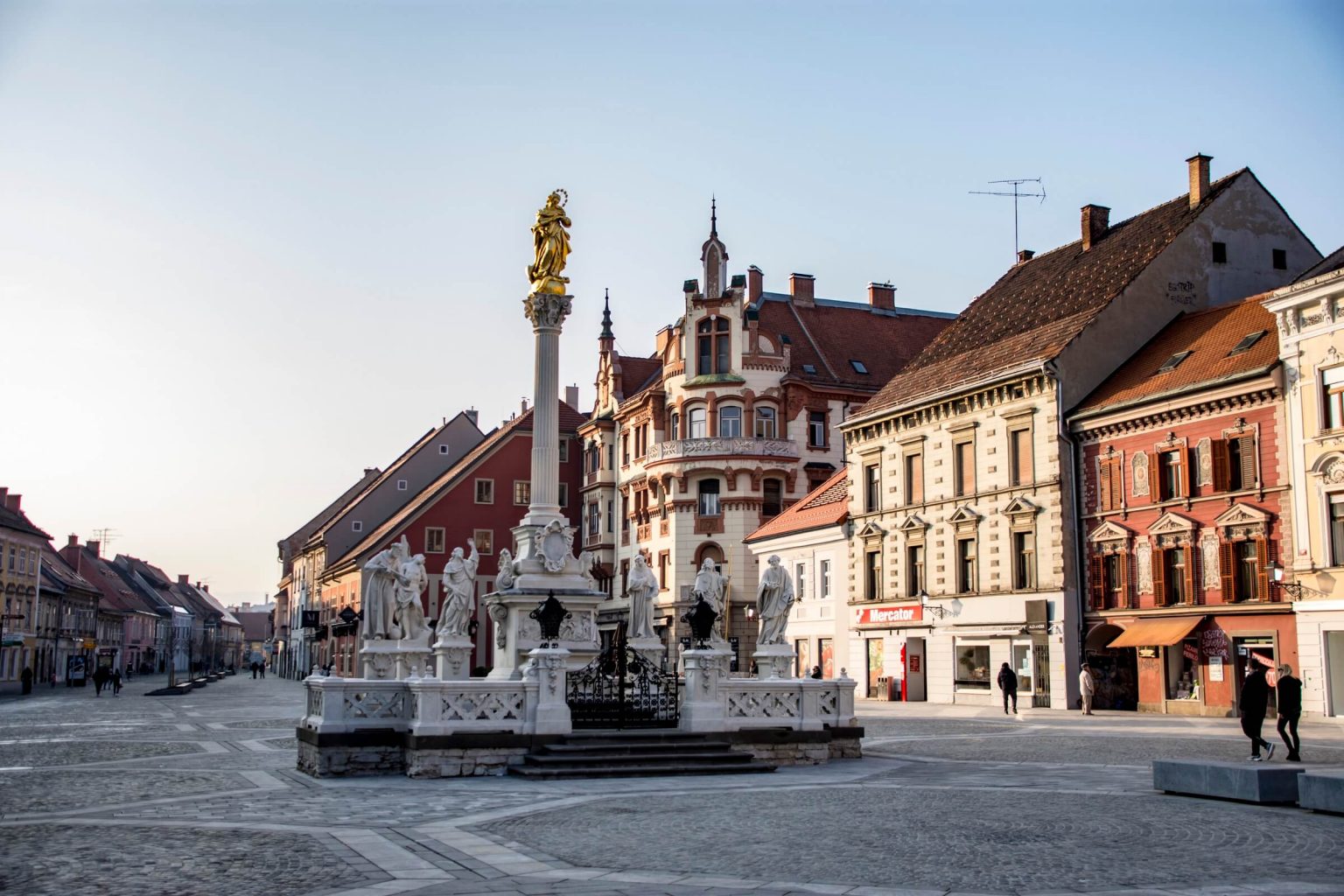 Maribor plague column with houses behind