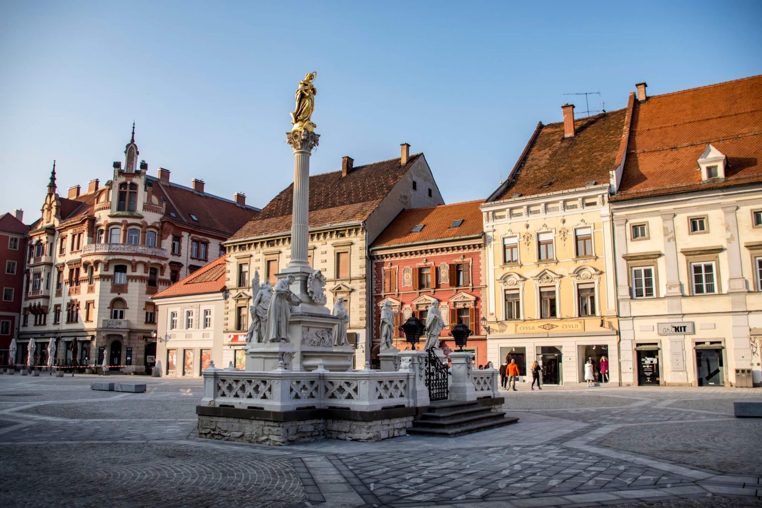 Maribor plague column with houses behind